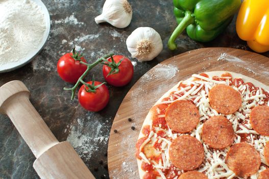 Pepperoni pizza preparation with fresh ingredients 