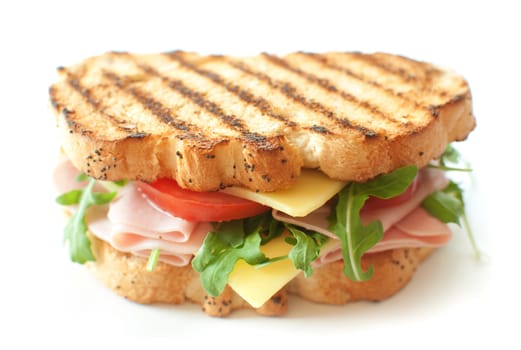 Grilled sandwich with ham and cheese and rocket salad 