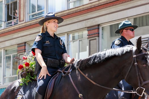 Portland, Oregon, USA - JUNE 7, 2014: Portland Police Mounted Patrol 
in Grand floral parade through Portland downtown.