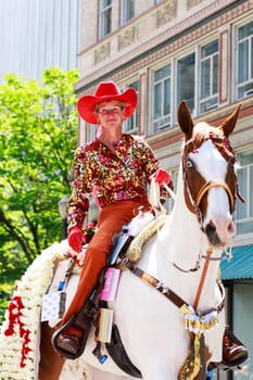 Portland, Oregon, USA - JUNE 7, 2014: Maggy Constantino in Grand floral parade through Portland downtown.