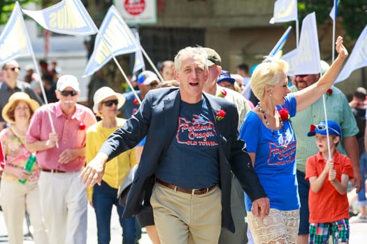 Portland, Oregon, USA - JUNE 7, 2014: Mayor Charlie Hales and wife in Grand floral parade through Portland downtown.