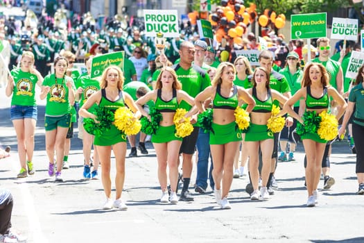 Portland, Oregon, USA - JUNE 7, 2014: University of Oregon Cheerleaders in Grand floral parade through Portland downtown.