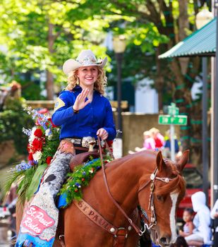 Portland, Oregon, USA - JUNE 7, 2014: St. Paul Rodeo Court in Grand floral parade through Portland downtown.