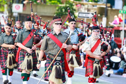 Portland, Oregon, USA - JUNE 7, 2014: Clan Macleay Pipe Band in Grand floral parade through Portland downtown.