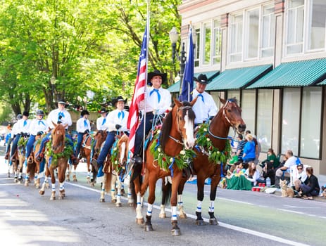 Portland, Oregon, USA - JUNE 7, 2014: Pacific Wild Horse Club in Grand floral parade through Portland downtown.