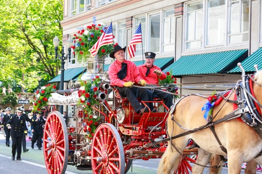 Portland, Oregon, USA - JUNE 7, 2014: Portland Fire & Rescue Vintage Steamer in Grand floral parade through Portland downtown.