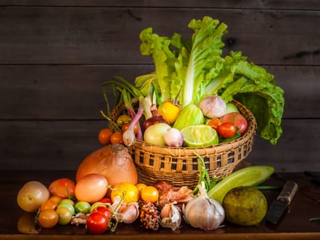 Still life of mix vegetable arranged with basket on old wooden