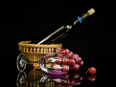 still life lightpaint wine and grape on black glass on black background