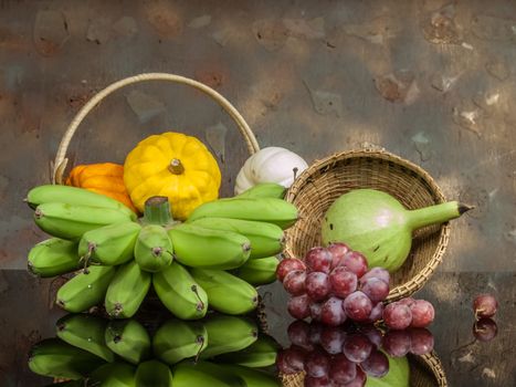 still life lightpaint color-full little pumpkins and banana and grape