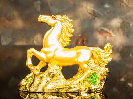 golden horse with wood background