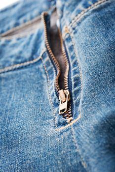 Closeup of blue denim jeans zipper