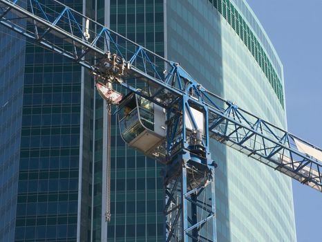 Cab of elevating crane on construction of the office building