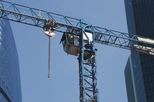 Cab of elevating crane on construction of the office building