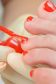 pedicure process macro closeup,  putting enamel on nails