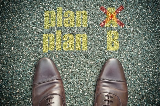 concept message on the road with feet - plan B