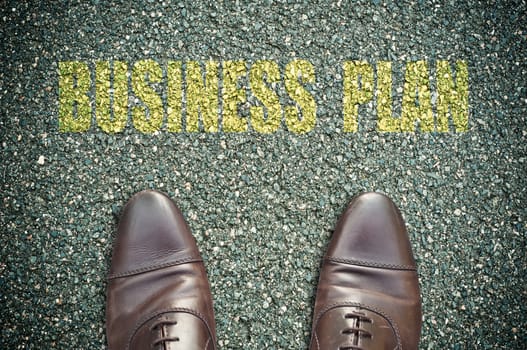 concept message on the road with feet - business plan