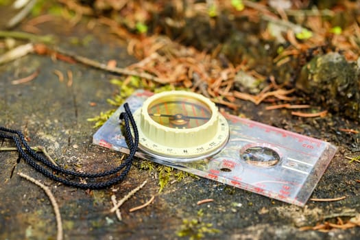 old touristic handheld compass on groung outdoor