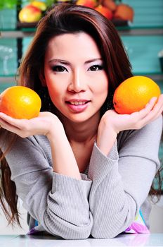 Happy asian woman cooking in the kitchen