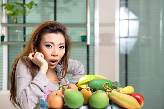 Happy asian woman cooking in the kitchen