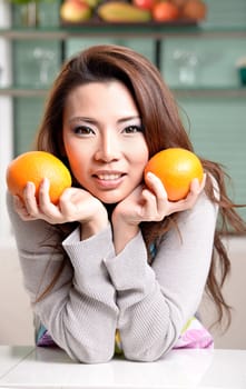 Happy asian woman cooking in the kitchen