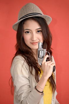 Young asian cute woman with handgun revolver