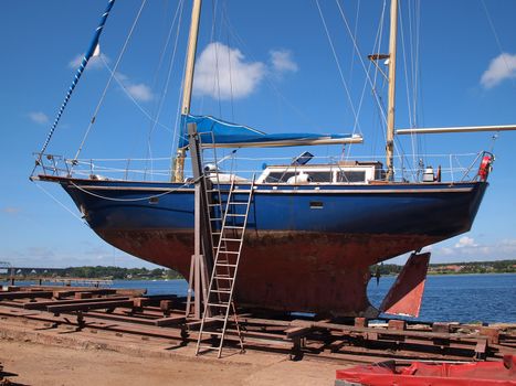  Yacht sailboat in a industrial shipyard for maintenance         