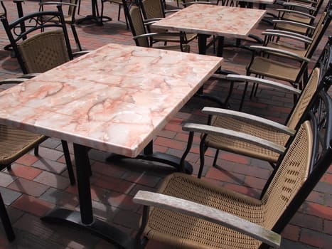 Classic style European street outdoors cafe restaurant with tables and chairs 
