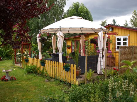 Beautiful Idyllic Wooden Summer house in a blooming garden