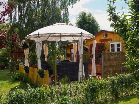 Beautiful Idyllic Wooden Summer house in a blooming garden