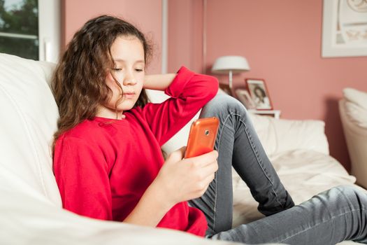 An image of a young girl with a mobile phone