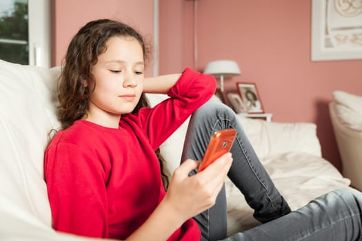 An image of a young girl with a mobile phone