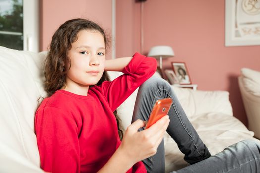 An image of a young girl with a mobile phone