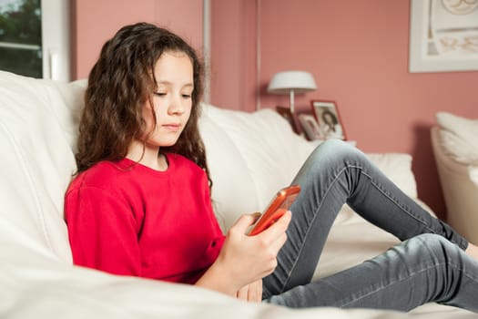 An image of a young girl with a mobile phone