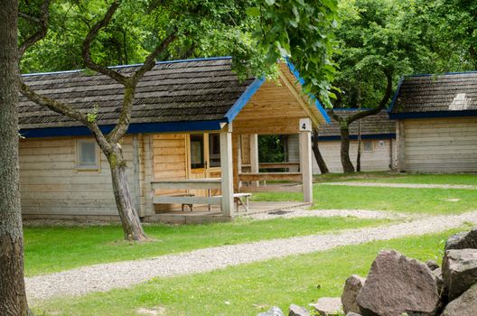 wooden double cottage with number of recreation park in summer time