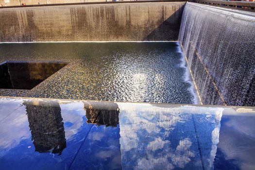 911 Memorial Pool Fountain Waterfall Reflections Abstract New York NY.  Pool is in the foundation of one of the Two World Trade Center Buildings.  Water falls into hole of the foundation.  