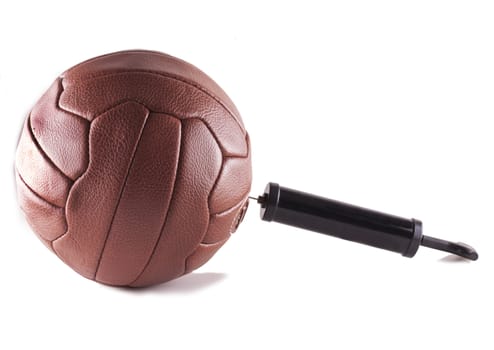 Pump inflating vintage football, isolated over white
