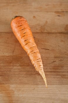 one Carrot on wooden board