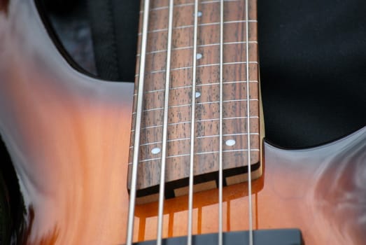 Electric bass guitar standing on stage.