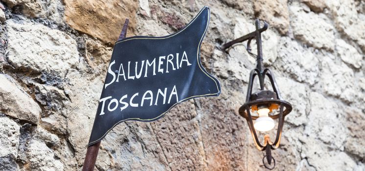 Tuscany, Italy. Traditional butchery streetsign on a old wall