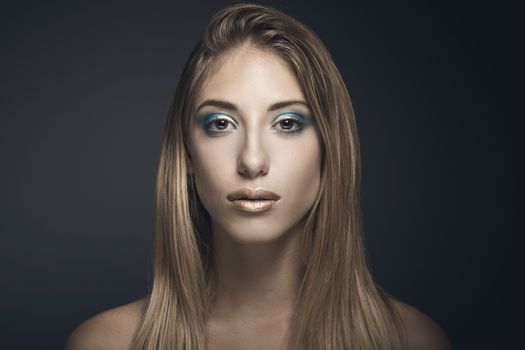 Beauty portrait of young sexy woman against blue background