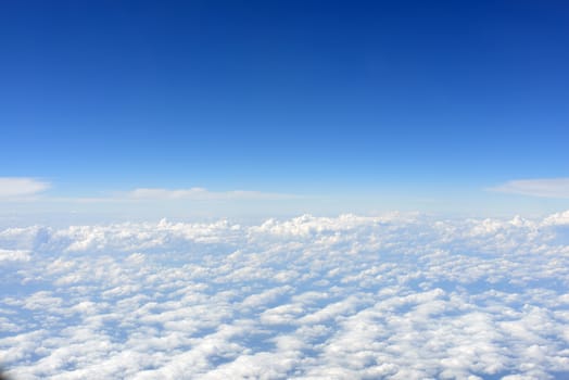 Blue sky and clouds. Top view of aircraft