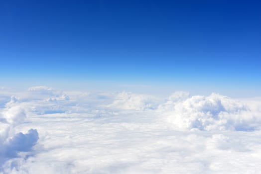 Blue sky and clouds. Top view of aircraft