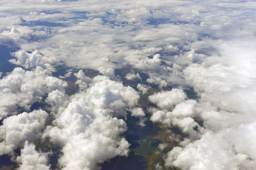 Earth's surface and clouds. Top view of aircraft