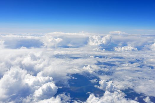 Blue sky and clouds. Top view of aircraft