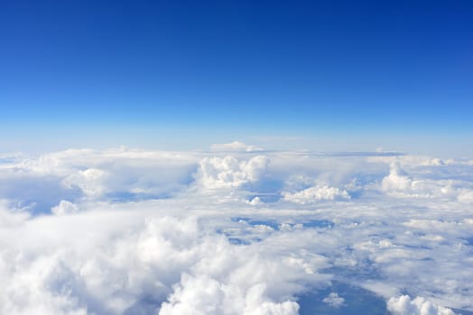 Blue sky and clouds. Top view of aircraft