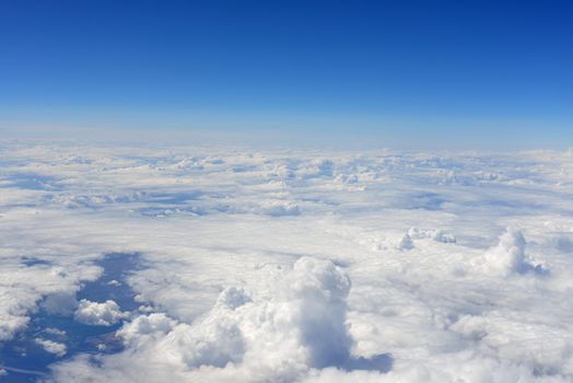 Blue sky and clouds. Top view of aircraft