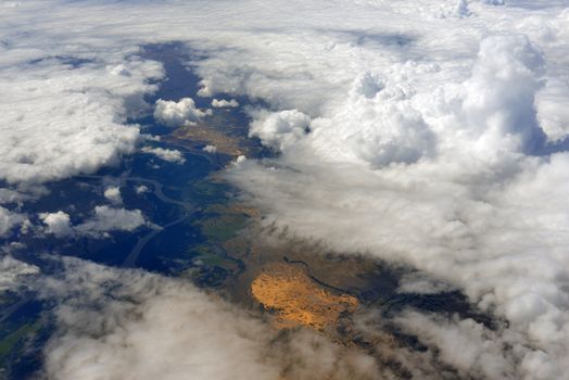 Earth's surface and clouds. Top view of aircraft