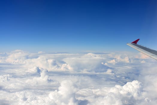 Airplane wing on a background of clouds