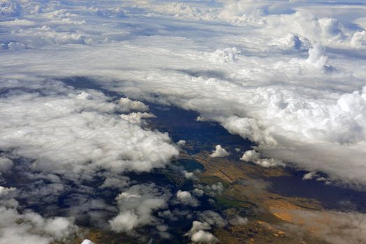 Earth's surface and clouds. Top view of aircraft