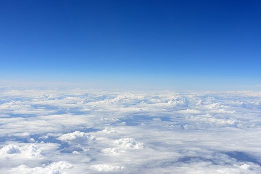Blue sky and clouds. Top view of aircraft